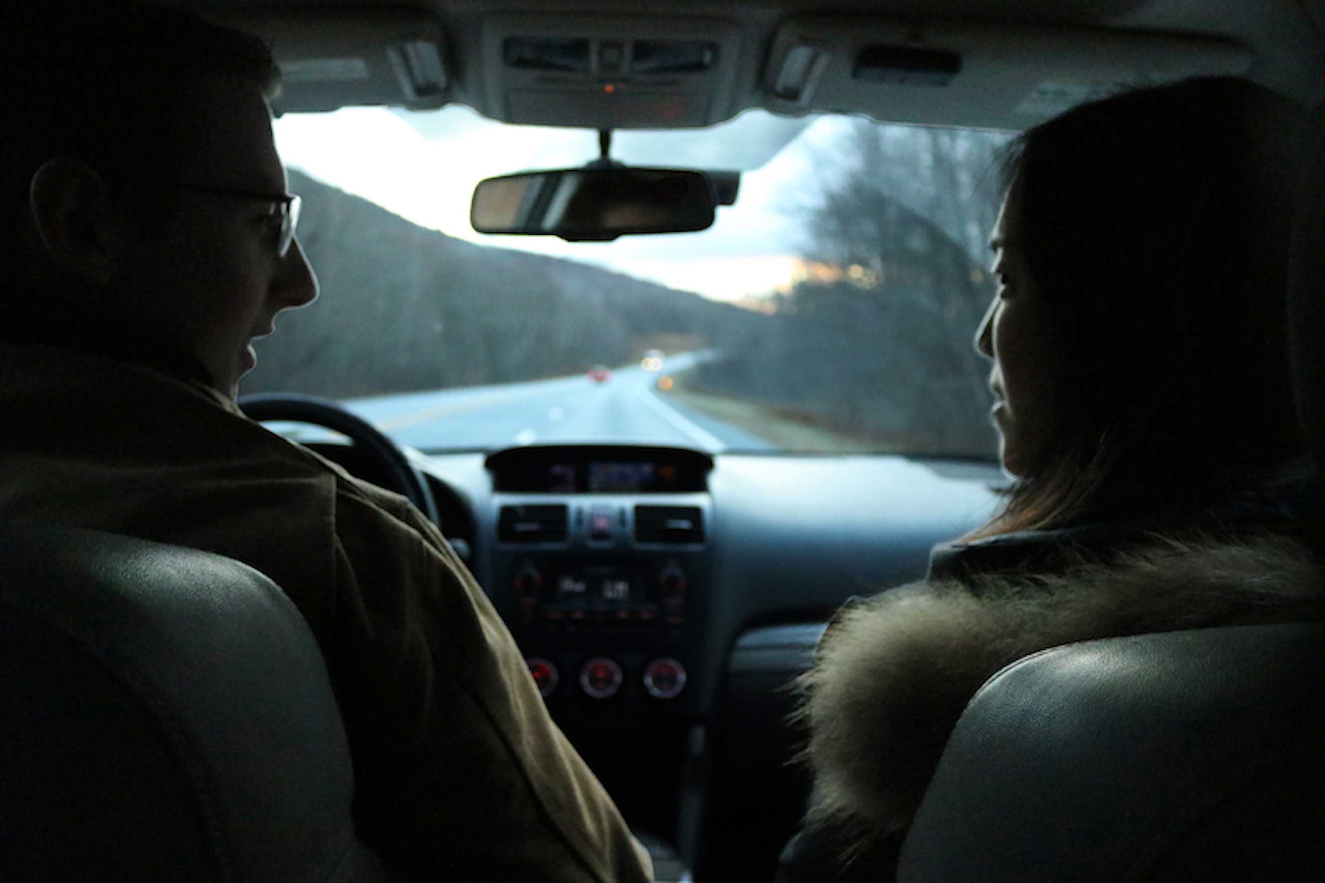 Photo of two people looking at each other in the car